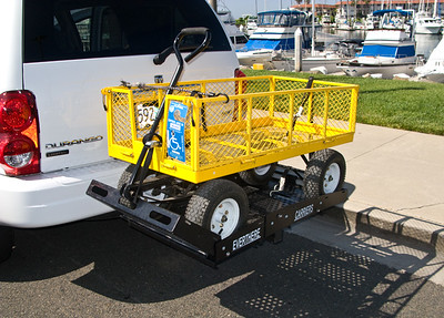 The Lowe's wagon on the carrier--a perfect fit. It can be  held firmly in place with two straps and takes only seconds to attach.

A simple BUNGEE CORD will keep the handle in place when driving, and also make sure the sides 
stay secure. 

The cart can be loaded and unloaded from the carrier by one person if you lower or lift it one axle at a time.

Two simple adjustable straps can attach by hooks to the holes in the carrier, then run around the wagon axle and secure. EASY!!

Click on image for LARGER VIEW. Click your BACK BUTTON to RETURN.